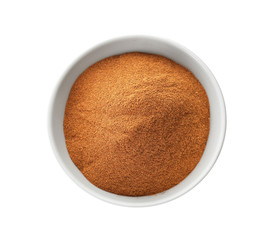 Bowl with aromatic cinnamon powder on white background