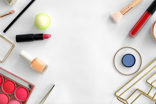 Flat lay composition with makeup products for woman on light background