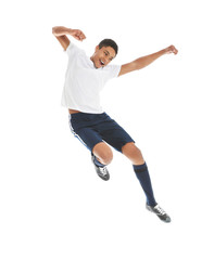 Fototapeta na wymiar Teenage African-American boy playing football on white background