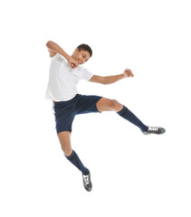 Teenage African-American boy playing football on white background