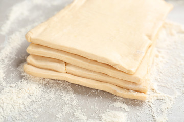 Fresh raw dough on table. Puff pastry