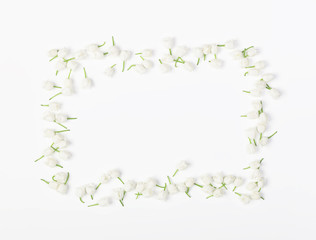 Floral frame made of lily of the valley isolated on white background. Top view. Flat lay.
