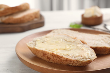 Fresh bread with tasty butter on plate