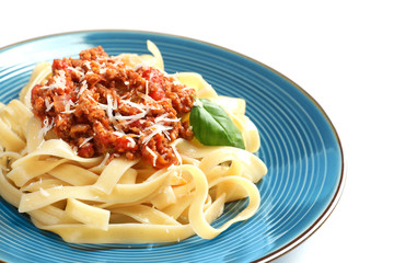 Plate with delicious pasta bolognese on white background