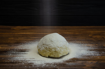 Prepare dough for baking. Adding flour for kneading manually.