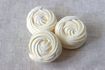 Three white zephyr on white tablecloth background.