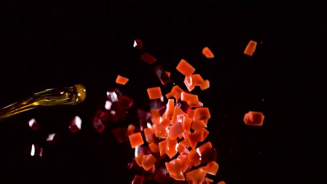 A jet of liquid knocks down part of the flying pieces of vegetables.