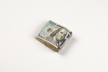 Stack of USA 100 dollars isolated on white background.