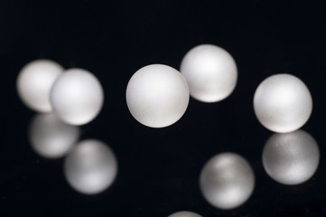 silver pearl balls on a black background