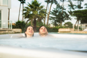 Young couple in a jacuzzi