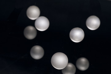 silver pearl balls on a black background