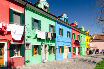 Red, blue, green and yellow hourses in the center of Burano near Venice