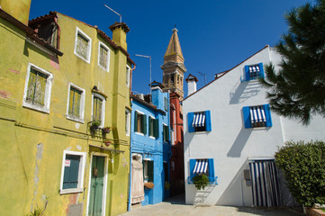 Bell tower and contrast of colorful houses in Burano near Venice.