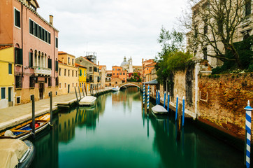 Cloudy view on a canal and colorful houses in Venice, Italy