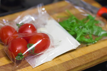 fresh products prepacked for salad. Tomatoes, sour cream, arugula.