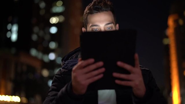 Portrait of a Guy using tablet at night