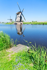 dutch windmill over river waters