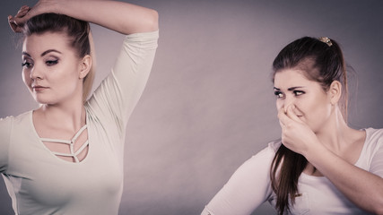 Woman having wet armpit her friend smelling stink