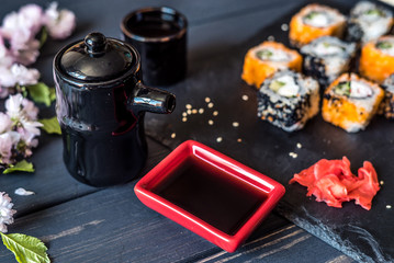 Obraz na płótnie Canvas sushi and appliances for sushi on a black background