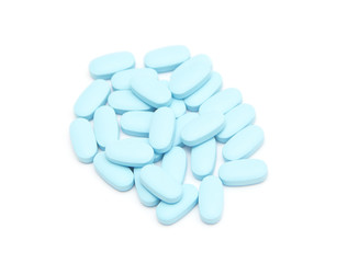 blue pills, capsules, tablets on white