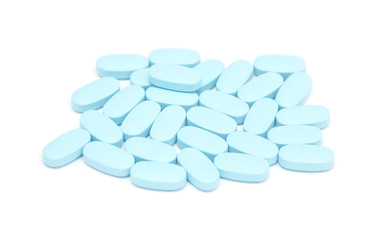 blue pills, capsules, tablets on white