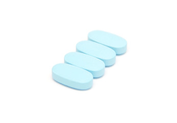 blue pills, capsules, tablets on white