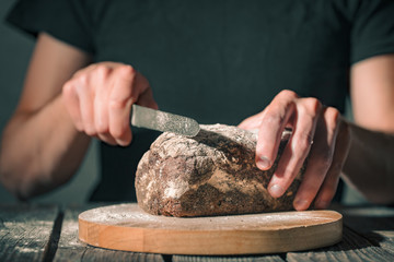 baker holding fresh bread in hands