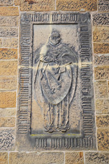 Statue on the wall of medieval building in an old European city.