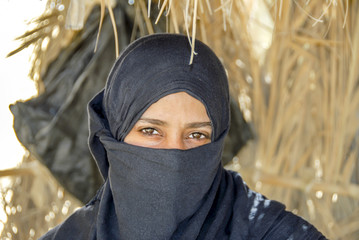 Sinai, Egypt, 18 February 2008: Close up of a Bedouin girl with hidden face behind veil posing at...