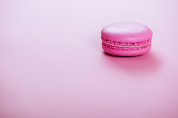 pink macaroons on pink background.