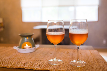Beer glasses with aroma lamp romantic time at fireplace