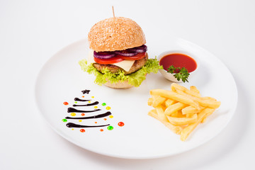 burger sauce and french fries on a  round  white plate