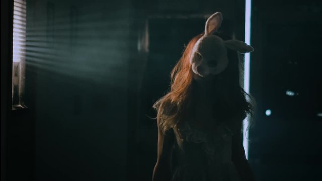 Creepy Bunny Girl Standing in a dark room