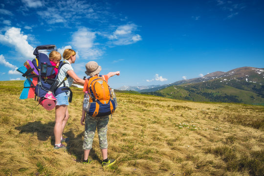 Family of hikers on a trekking day in a mountain valley