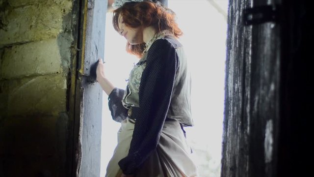 girl in an ethnic dress enters a country barn. Fairy-tale character. Cinderella