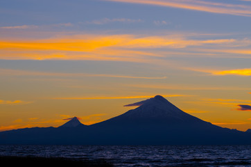 Sunrise in Lake Llanquihue and in the city of the same name, with the Osorno and Puntiagudo volcanoes at the background, southern Chile