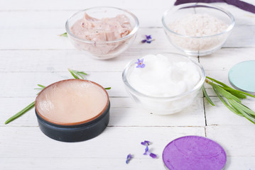 grooming products and fresh lavender bouquet on white wooden table background