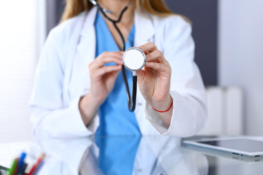 Female doctor holds stethoscope head, just hands closeup. Physician ready to examine and help patient. Medical help and insurance in health care, best treatment and medicine concept
