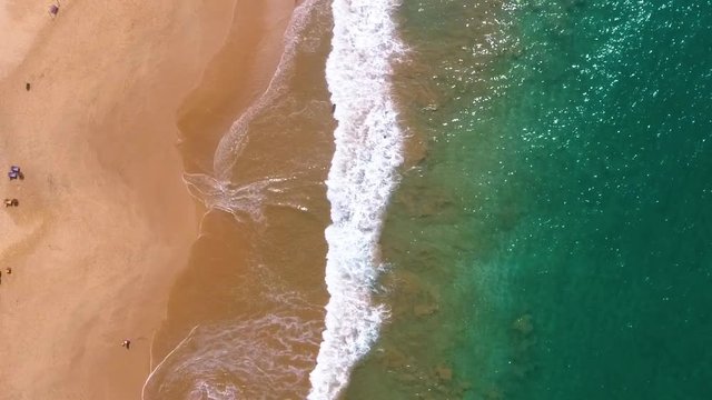 Aerial view of waves crashing onto the shore