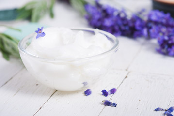grooming products and fresh lavender bouquet on white wooden table background