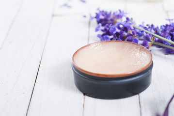 makeup base and lavender on white wood table background