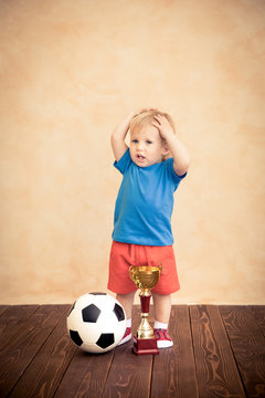 Child is pretending to be a soccer player