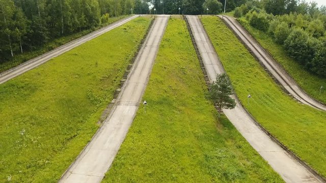 Aerial view Road for a drive test drive, climb up the slope. Simulation of climbing uphill for vehicle testing.Test road in the forest for testing and fine-tuning cars. 4K, aerial footage.
