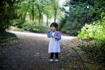 baby girl play at spring forest garden