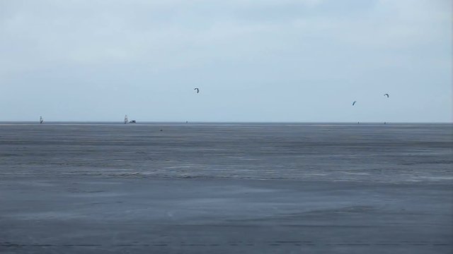 unrecognizable sportsman on skates with a kitewing in hands, tracking shot