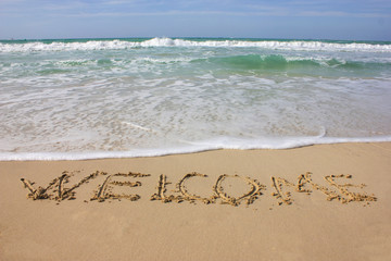 "Welcome" in den Sand geschrieben