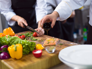 Chef hands preparing marinated Salmon fish