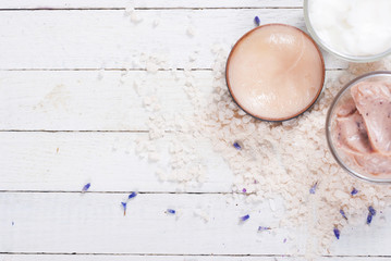 cosmetic creams and lavender on white wood table background