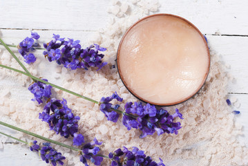 Fototapeta na wymiar makeup base, bath salt and lavender on white wood table background