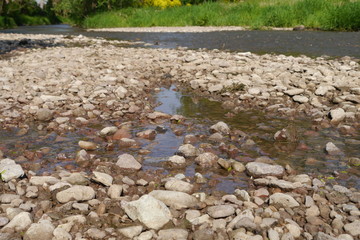 Flusskies und Pfützen am Fluss.